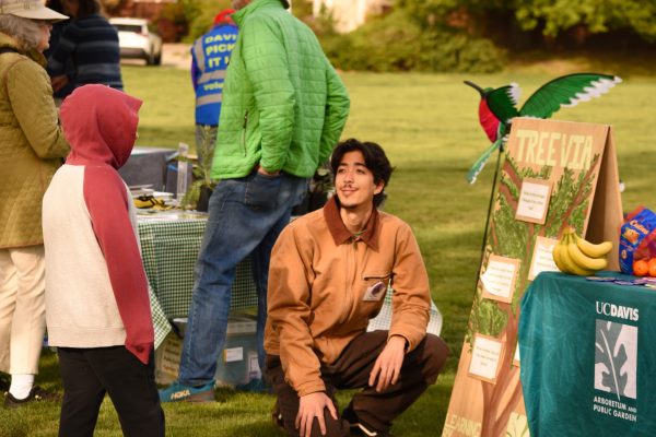 Child chats with Arboretum fellow at Arbor Day 2025.