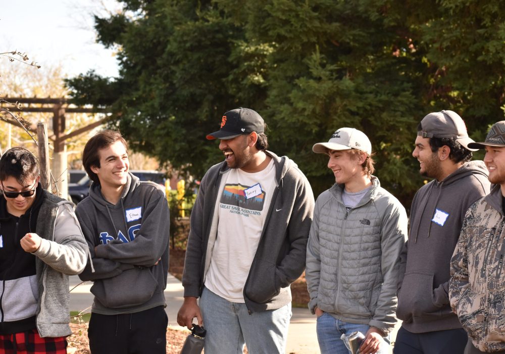 Volunteers chat and laugh with one another.