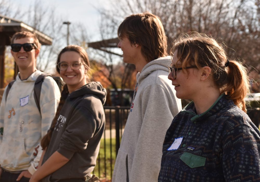 Volunteers stand and smile.