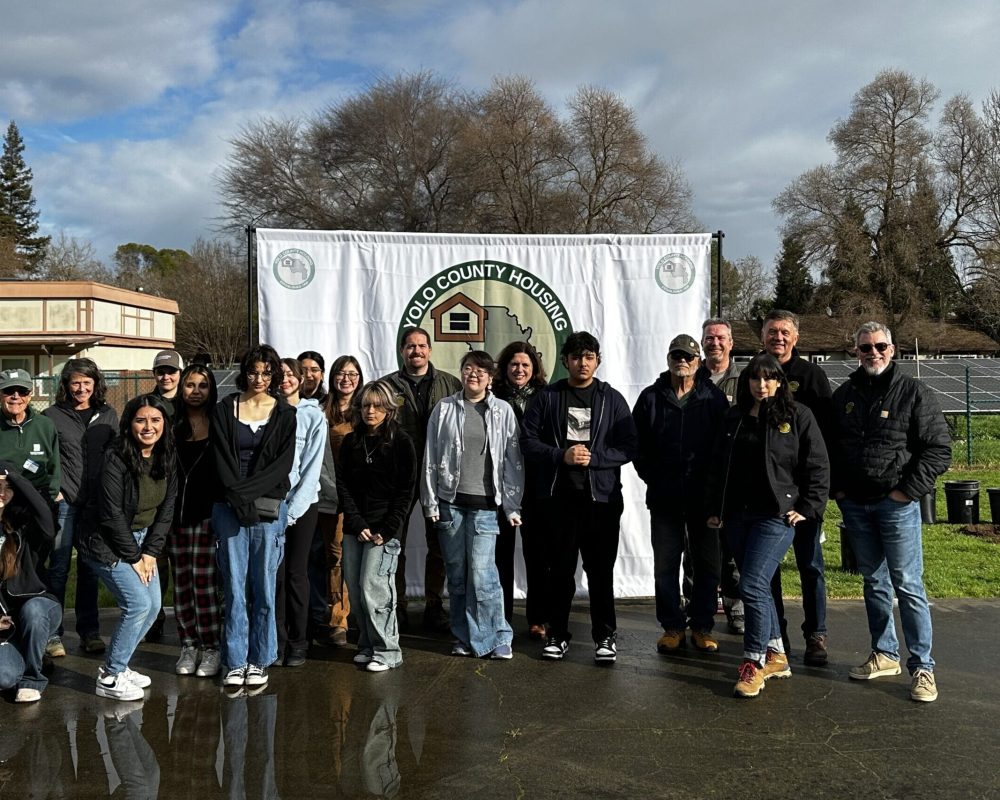 Students from the Climate-Ready Urban Forestry Education Program pose at a Yolo County Housing Planting event.